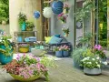 Bunte Blumen und grüne Pflanzen auf einer Terrasse, mit Hängekörben und Kissen. Tolle gartendeko ideen für Ihr Zuhause.