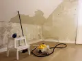 Tapete entfernen: Ein Dampfreiniger und Werkzeuge liegen bereit, um die alte Tapete von den Wänden zu lösen.