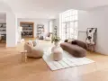 Ein helles Wohnzimmer mit organischen Sofas und einem Essbereich. Verschiedene einrichtungsstile arten werden hier modern interpretiert.