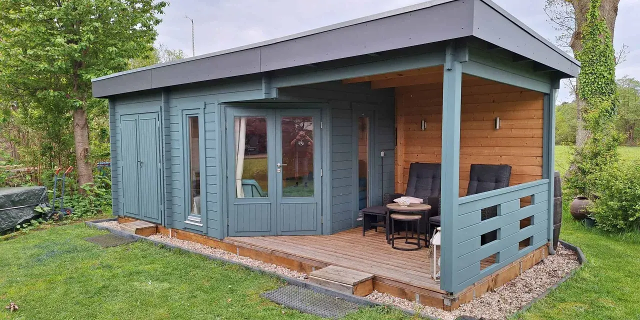 Ein blaugrünes Gartenhaus mit Veranda und Sitzgelegenheiten. Tolle Gartenhaus Farben Ideen für Ihr grünes Paradies.