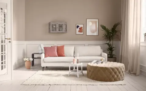 Gemütliches Wohnzimmer mit beigem Teppich und Hocker. Hier siehst du, wie man beige mit anderen Farben mischt.