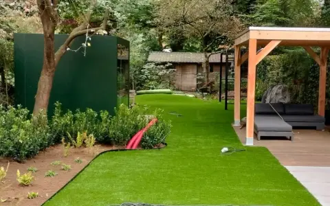 Moderne Gartenaufteilung mit Kunstrasen, Holzpavillon, Lounge-Möbeln und grüner Wand. Tolle Ideen für Ihren Garten!