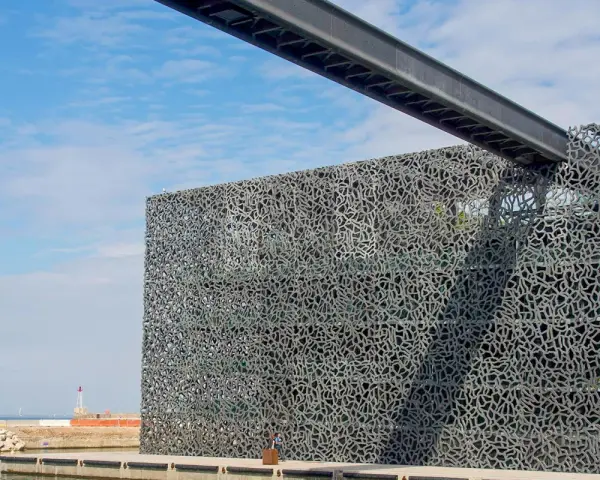 Das MuCEM Marseille mit seiner faszinierenden Gitterfassade, die wie ein Netz wirkt, ragt am Hafen auf.