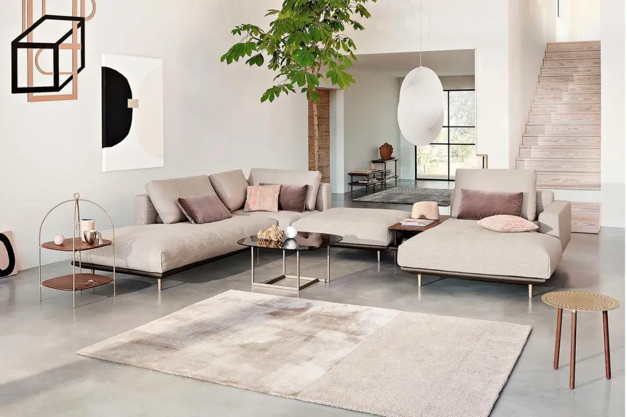 Modernes Wohnzimmer mit beigem Ecksofa, Glascouchtisch und Teppich. Verschiedene einrichtungsstile arten sind hier elegant vereint.
